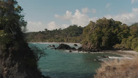 Aerial,-Drone-flying-through-the-rocks-in-the-ocean-of-Costa-Rica