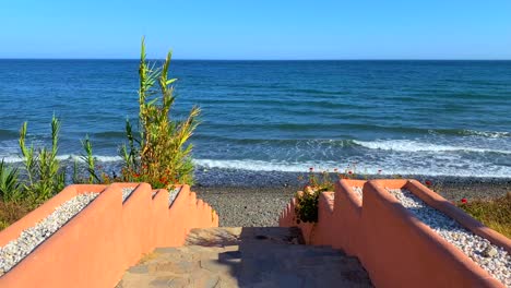 Beautiful-stairs-to-the-ocean,-steps-leading-down-to-the-sea-in-Marbella-Estepona,-Spain,-4K-static-shot