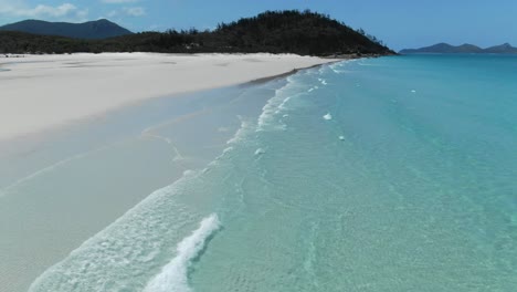 Drone-Flying-Fast-over-Small-waves-and-two-people-at-Queenslands-Incredible-White-Haven-Beach,-Aerial