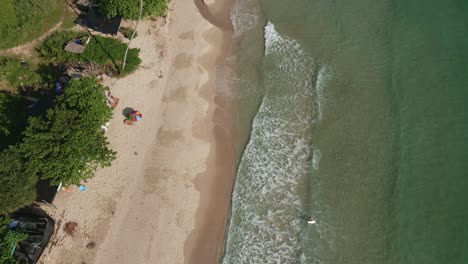 Aerial-dolly-shot-of-paradise-beach-in-Thailand-with-waves-crashing-in-slow-motion
