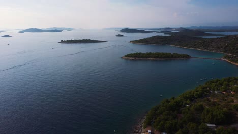 Amazing-aerial-view-panning-up-revealing-coastline-of-Dalmatia,-Croatia-filmed-in-4k-with-clear-water,-beaches-and-rocky-shore-of-the-Adriatic-Sea
