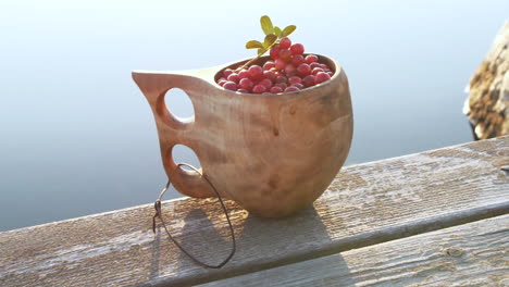 Healthy-Nordic-berries-in-traditional-wooden-Kuksa-cup