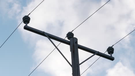 Electricity-supply-pole-and-cables-outside,-low-angle-shot