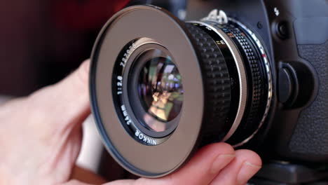 Male-hand-adjusts-manual-focus-ring-on-a-DSLR-lens