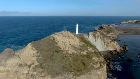 Lighthouse-Tower-on-Castlepoint-Rock-in-New-Zealand,-Aerial-Drone-Pullaway