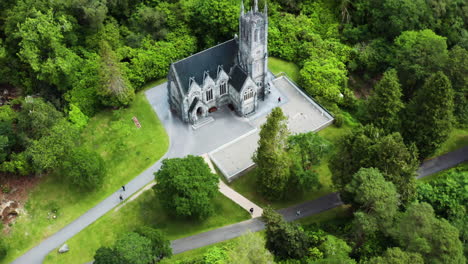 Incredible-Architecture-of-Castle-in-Kylemore-Abbey-Historical-Gardens---Aerial-Drone-Tilt-up-Reveal