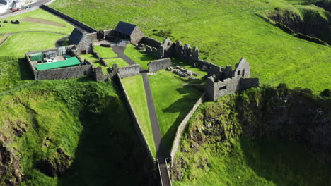 Aerial-birdseye-shot-of-ruins-of-the-medieval-Dunluce-Castle-in-Ireland