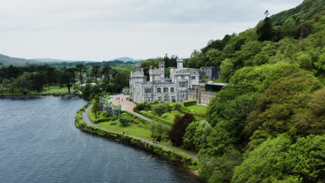 Castle-Kylemore-Abbey-Gardens-in-Connemara,-Galway,-Ireland---Aerial-Drone