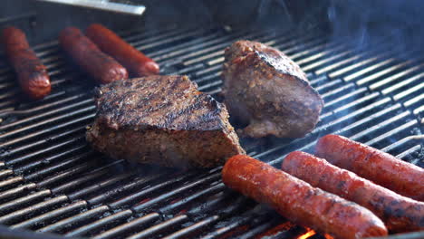 Steaks-and-hotdogs-sizzling-as-they-grill-on-the-barbecue