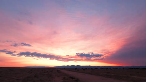 Stunning-colorful-sunset-against-the-backdrop-of-the-Mojave-Desert-and-the-distant-mountain-range---static-time-lapse