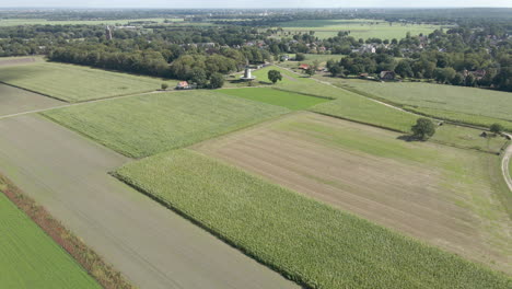 Wide-aerial-dolly-of-traditional-windmill-surrounded-by-farmland