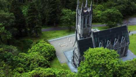Ireland---Gothic-Style-Architecture-on-Kylemore-Abbey-Castle-Building,-Aerial-Drone-Pullaway