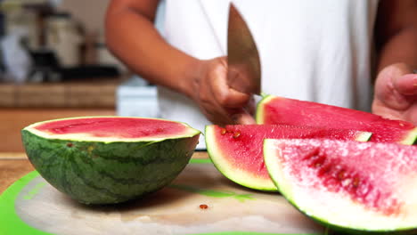 Slicing-big-wedges-of-home-garden-grown-watermelon-ripe,-sweet-and-juicy