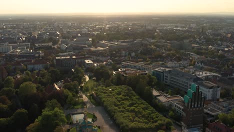 Leaving-Darmstadt-and-the-Mathildenhoehe-on-a-sunny-summer-evening-with-a-drone-showing-the-city-in-the-background