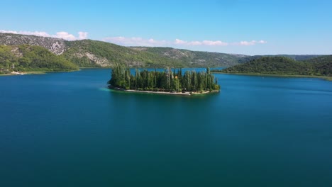 Stunning-aerial-view-of-Visovac-Monastery-Island-flying-forward-across-Krka-National-Park-lakes-in-Dalmatia,-Croatia-filmed-in-4k