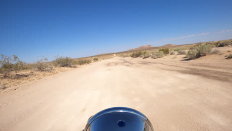 A-hot-and-lonely-motorcycle-ride-through-the-Mojave-Desert-wilderness-landscape-in-the-heat-of-the-day---rider-point-of-view