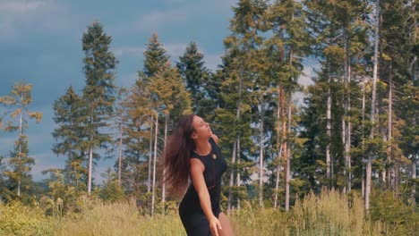 Energetic-carefree-young-caucasian-woman-twirling-in-forest,-slow-motion