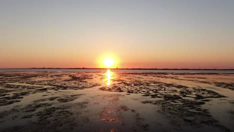 Stunning-Orange-Sunset-Over-Tidal-Flat-Of-North-Sea-In-Germany