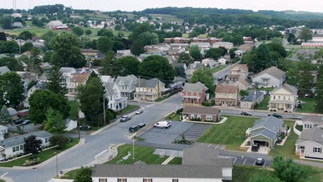 Aerial-of-small-town-rural-America,-trailer-park-homes-and-older-two-story-houses-line-street,-establishing-shot-for-United-States-USA-neighborhood-community-development-setting