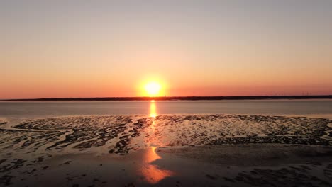 Stunning-Clear-Orange-Sunset-Over-Tidal-Flat-Of-North-Sea-In-Germany-Near-Husum