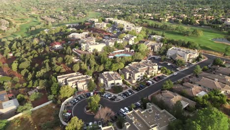 Aerial-view-over-a-community-of-condos,-on-a-sunny-evening,-in-Sedona,-Arizona,-USA---Dolly,-drone,-shot