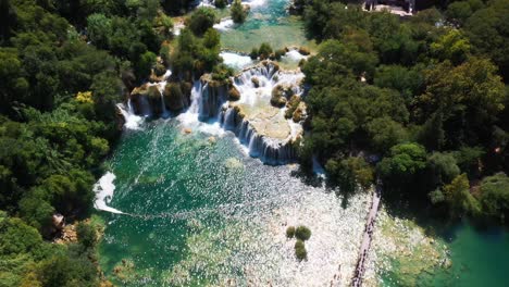 Amazing-aerial-view-panning-up-revealing-lakes-and-waterfalls-at-Krka-National-Park-in-Dalmatia,-Croatia-filmed-in-4k