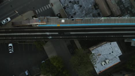 Birds-Eye-View-of-Subway-Train-Crossing-over-Street