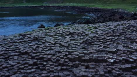 Giant's-Causeway-Basalt-Columns,-Ancient-Rock-Formation,-Aerial-Drone-Flyover