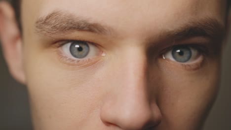 Young-Man-Facing-Too-Close-To-The-Camera-With-Eyes-Wide-Open---Extreme-Closeup-Shot