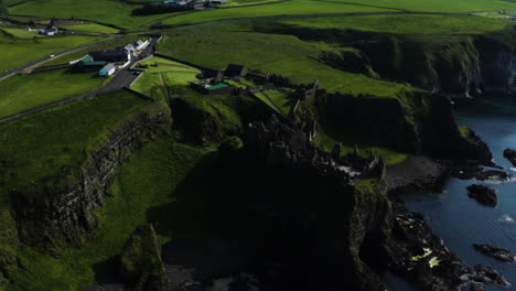 Aerial-pan-left-shot-of-the-Dunluce-Castle-from-afar