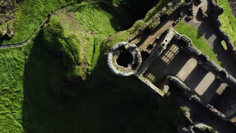 Dunluce-Castle,-Ireland---Overhead-Aerial-Spinning-Over-Fortress-Turret