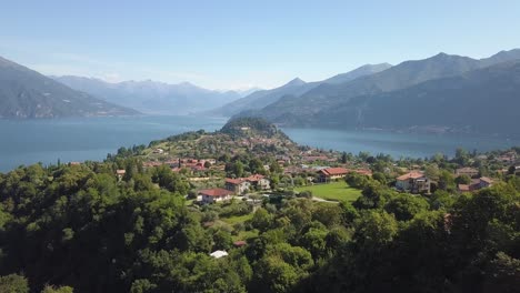 Fly-over-a-small-village-near-a-lake-in-Italy-Alps-Mountain-area,-Bellagio,-Lago-di-Como,-Italy