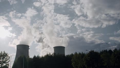 Cooling-Towers-in-Power-Plant-Generating-Steam-Against-Cloudy-Sky