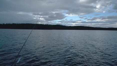 Fishing-rod-on-a-lake-on-a-cloudy-evening-sky