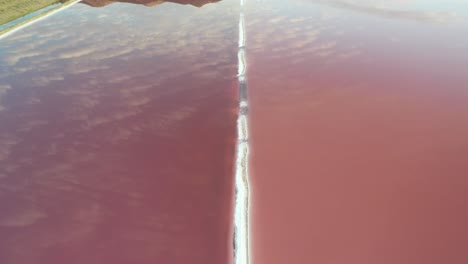 Aerial-view-of-pink-ponds-water-and-sky-mirror-reflection