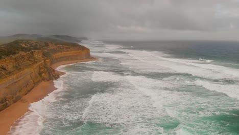 The-Twelve-Apostles-Coastline-and-Cliffs,-drone-viewpoint-on-a-cloudy-afternoon