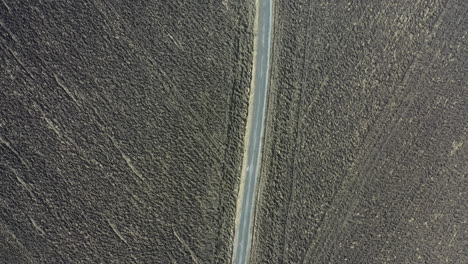 Winding-deserted-road-in-between-two-farm-fields