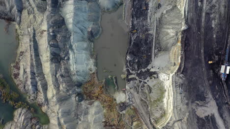 Top-down-arial-view-of-a-sand-quarry-pit-wit-small-lakes
