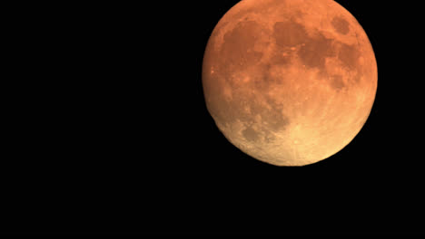 Large-Orange-Full-Moon-Rising-In-The-Sky,-Night-Astro-Time-Lapse