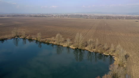 Agriculture-land-and-small-lake-drone-view