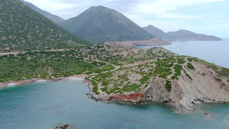 Aerial-view-of-the-coastline-of-Crete-surrounded-by-clear-waters