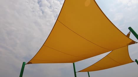 Arc-on-cloth-sun-shade-sails-over-playground-equipment
