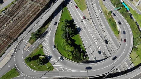 Aerial-view-over-busy-intersection-and-railway-lines,-Sweden