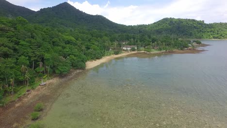 Drone-shot-of-tropical-Island-coastline-with-jungle,-beach,-mangroves-and-small-resort