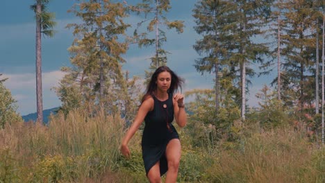 Slow-Motion-of-Sensual-Dance-of-a-Young-Sexy-Woman-in-Black-Dress-on-Summer-Day-in-Green-Countryside-Landscape