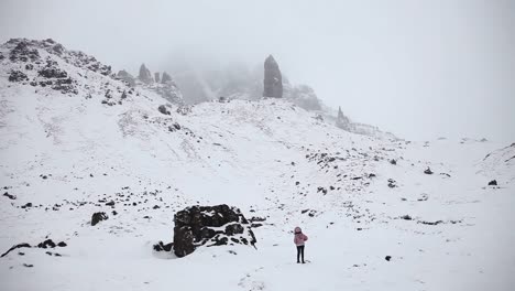 Adventurer-looking-around-winter-scene,-highlands,-Scotland,-panoramic-shot,-wide-angle