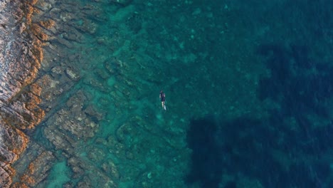 Top-down-View-Of-A-Man-Snorkeling-In-The-Crystal-Clear-Blue-Water-In-Losinj-Island,-Croatia