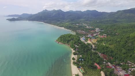 Dense-idyllic-Koh-Chang-island-coastline-turquoise-ocean-resort-travel-destination-aerial-view