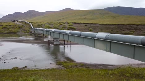 Sistema-De-Oleoductos-Trans-alaska-Sobre-El-Río-En-La-Campiña-De-Alaska---Drone-Aéreo