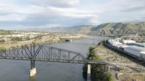 The-Old-Wenatchee-Bridge-Spanning-Across-The-Columbia-River-In-Wenatchee,-Washington-State---aerial-drone,-tracking-shot